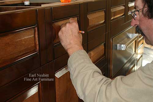 Earl checks pull placement on custom made cabinet